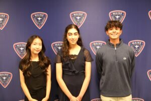 District 207's best in Academic Achievement students standing in front of a blue background with D207 logos on it