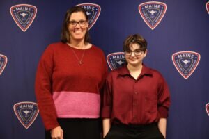 Maine West student named Ray Copeland and next to him is Maine West principal Dr. Eileen McMahon.