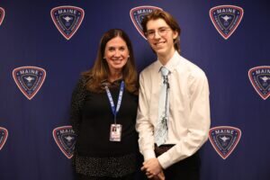 Maine East student named Jackson Horvath and next to him is Maine East principal Dr. Melissa A. Pikul.