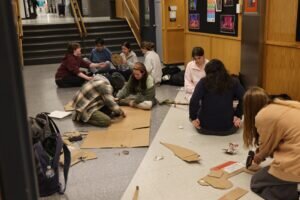 Group of students working on an creating art in the hallway