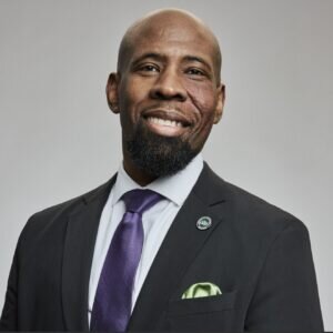Portrait of Daniel Hill posed in front of a grey background