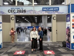 Maine West teachers Gaby Goldman and Theresa Hardin in front of the Welcome to CEC 2026 sign in Salt Like City