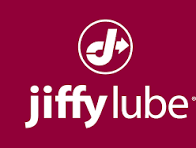 Jiffy Lube logo on a maroon background, featuring a stylized J with an arrow inside a circle above the words jiffy lube in white lowercase letters.
